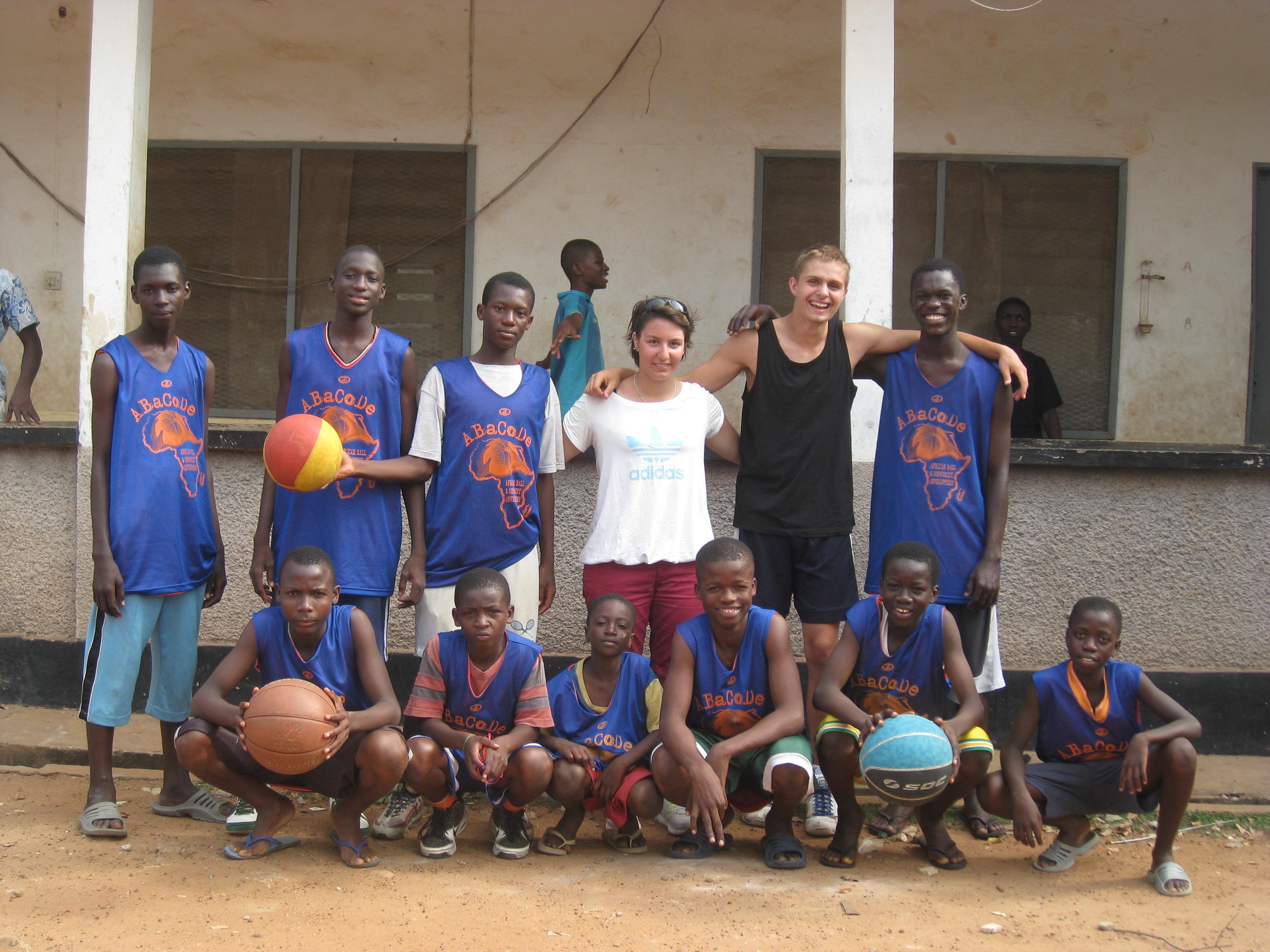 A sports team poses with their volunteer basketball coaches in Ghana Projects Abroad volunteers teach basketball in Ghana to a local sports team
